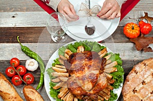 Homemade roasted whole turkey on wooden table for Thanksgiving.