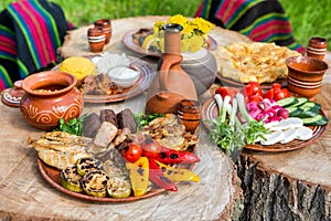 Homemade Romanian Food with grilled meat, polenta and vegetables Platter on camping.