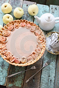 Homemade rose apple tart with cream filling served with tea and