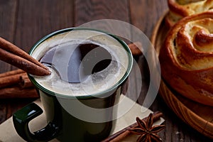 Homemade rose bread, cup of coffee, anise and cinnamon on vintage background, close-up, selective focus
