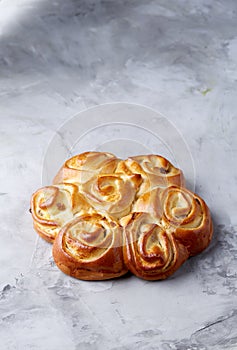 Homemade rose bread on white textured background, close-up, shallow depth of field, top view