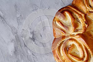 Homemade rose bread on white textured background, close-up, shallow depth of field, top view