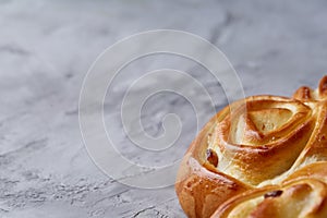 Homemade rose bread on white textured background, close-up, shallow depth of field, top view