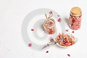 Homemade rose petals jam in bowl and glass jar