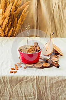 Homemade rustic apple and pear crumble in portion of red ceramic