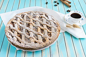 Homemade rustic apple tart pie on dish over wooden turquoise background