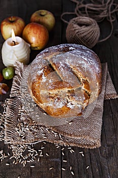 Homemade rustic bread over wooden background