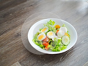 Homemade salad with fresh vegetables, crab stick, eggs