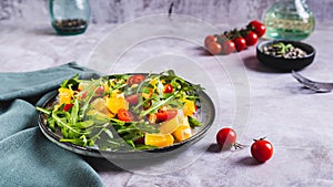 Homemade salad of orange, cherry tomatoes and arugula on a plate web banner