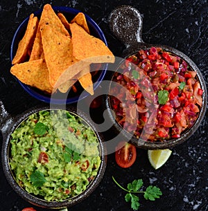 Homemade salsa and guacamole with corn chips