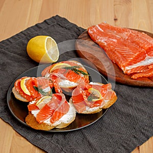 Homemade salted salmon toasts with creamcheese on plate photo