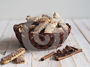 Homemade sandwich puff pastry chocolate cookies in a wicker natural basket of vines. Wooden ancient table