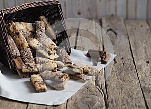 Homemade sandwich puff pastry chocolate cookies in a wicker natural basket of vines. Wooden ancient table