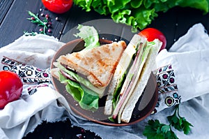 Homemade sandwich with salad and juice as a healthy breakfast