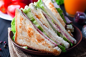 Homemade sandwich with salad and juice as a healthy breakfast