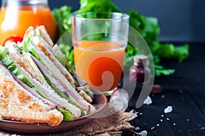 Homemade sandwich with salad and juice as a healthy breakfast