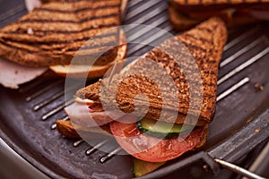 Homemade sandwiches lie on the groa grill