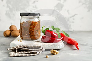 Homemade sauce adjika with vegetables and walnuts