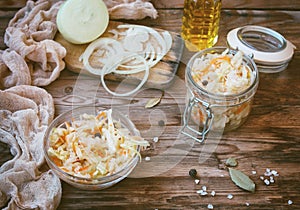 Homemade sauerkraut in glass bowl on wooden table