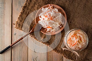 Homemade sauerkraut on a linen background. Rustic style, canned vegetables on a light wooden background. Eco food, the trend of