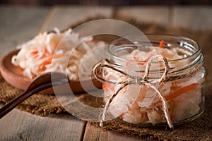 Homemade sauerkraut on a linen background. Rustic style, canned vegetables on a light wooden background. Eco food, the trend of