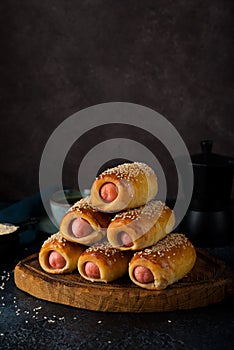 Homemade sausages in dough  pigs in blanket on a wooden board