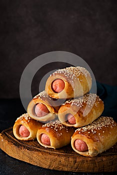 Homemade sausages in dough  pigs in blanket  on a wooden board