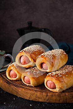 Homemade sausages in dough  pigs in blanket  on a wooden board