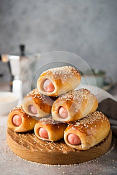 Homemade sausages in dough on a wooden board, fast food