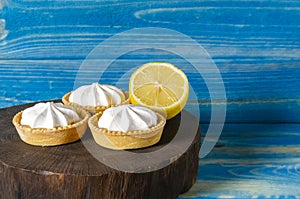 Homemade shortbread mini tart cakes with lemon curd and whipped cream,white grey concrete background copy space