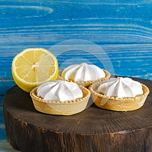 Homemade shortbread mini tart cakes with lemon curd and whipped cream,white grey concrete background copy space