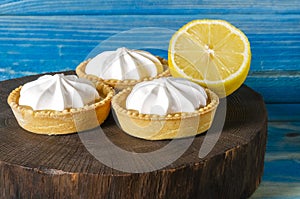 Homemade shortbread mini tart cakes with lemon curd and whipped cream,white grey concrete background copy space