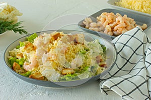 Homemade Shrimp Caesar Salad with parmesa, sauce and Croutons on a white background