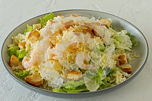 Homemade Shrimp Caesar Salad with parmesa, sauce and Croutons on a white background