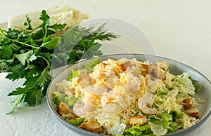 Homemade Shrimp Caesar Salad with parmesa, sauce and Croutons on a white background