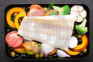 Homemade simple healthy. Farmer market vegetables white cod fish on a baking tray: zucchini, corn, purple onion, colored