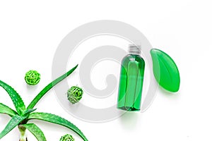 Homemade skin care. Aloe vera leafs, glass of aloe vera juice and soap on white background top view copyspace