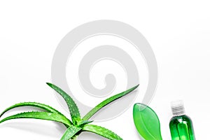 Homemade skin care. Aloe vera leafs, glass of aloe vera juice and soap on white background top view copyspace