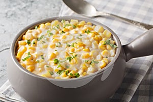 Homemade Slow Cooker Creamed Corn in a Bowl closeup on the bowl. Horizontal