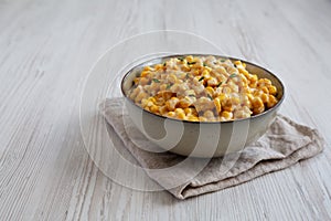 Homemade Slow Cooker Creamed Corn in a Bowl, low angle view. Space for text
