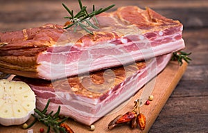 Homemade smoked bacon on wooden board photo