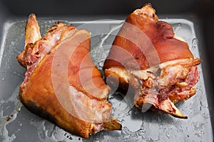 Homemade smoked ham hocks in a grey roasting pan photo