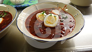 Homemade soup with tomatoes, beetroot, cream eggs and parsley.