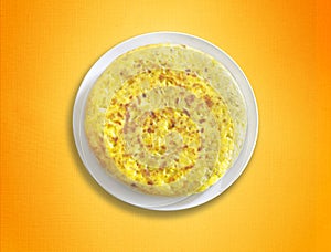 Homemade spanish omelette on orange tablecoth.