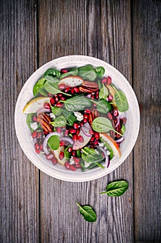 Homemade spinach, apple, pecan, red onion salad with goat cheese and pomegranate