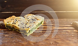 Homemade spinach french pie on a white wooden board