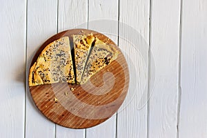 Homemade spinach french pie on a white wooden board