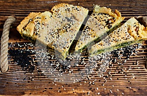 Homemade spinach french pie on a white wooden board