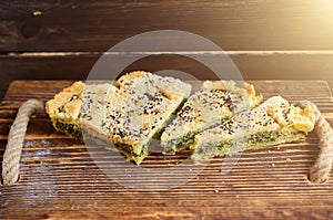 Homemade spinach french pie on a white wooden board