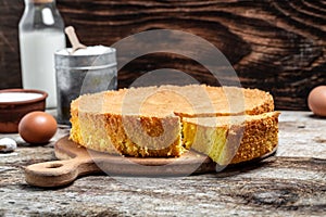 Homemade sponge cake or chiffon cake with ingredients on wooden table. Bakery background concept. banner, menu recipe place for